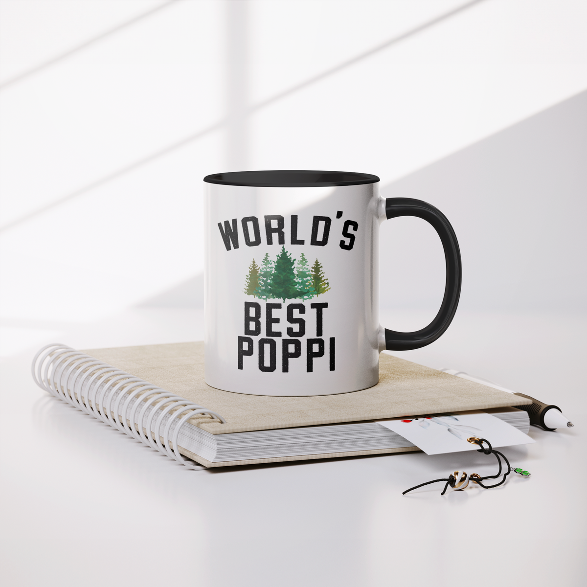 Worlds_Best_Poppi_Forest_Coffee_Mug_Mug_Lifestyle_Notebook_Mockup.png_13293238