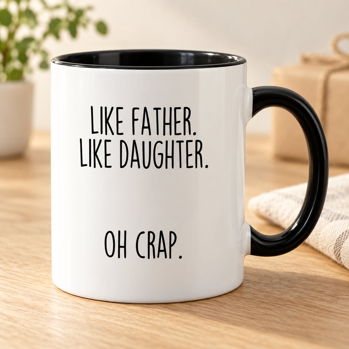 Black-handled mug with the original Like Father, Like Daughter design.