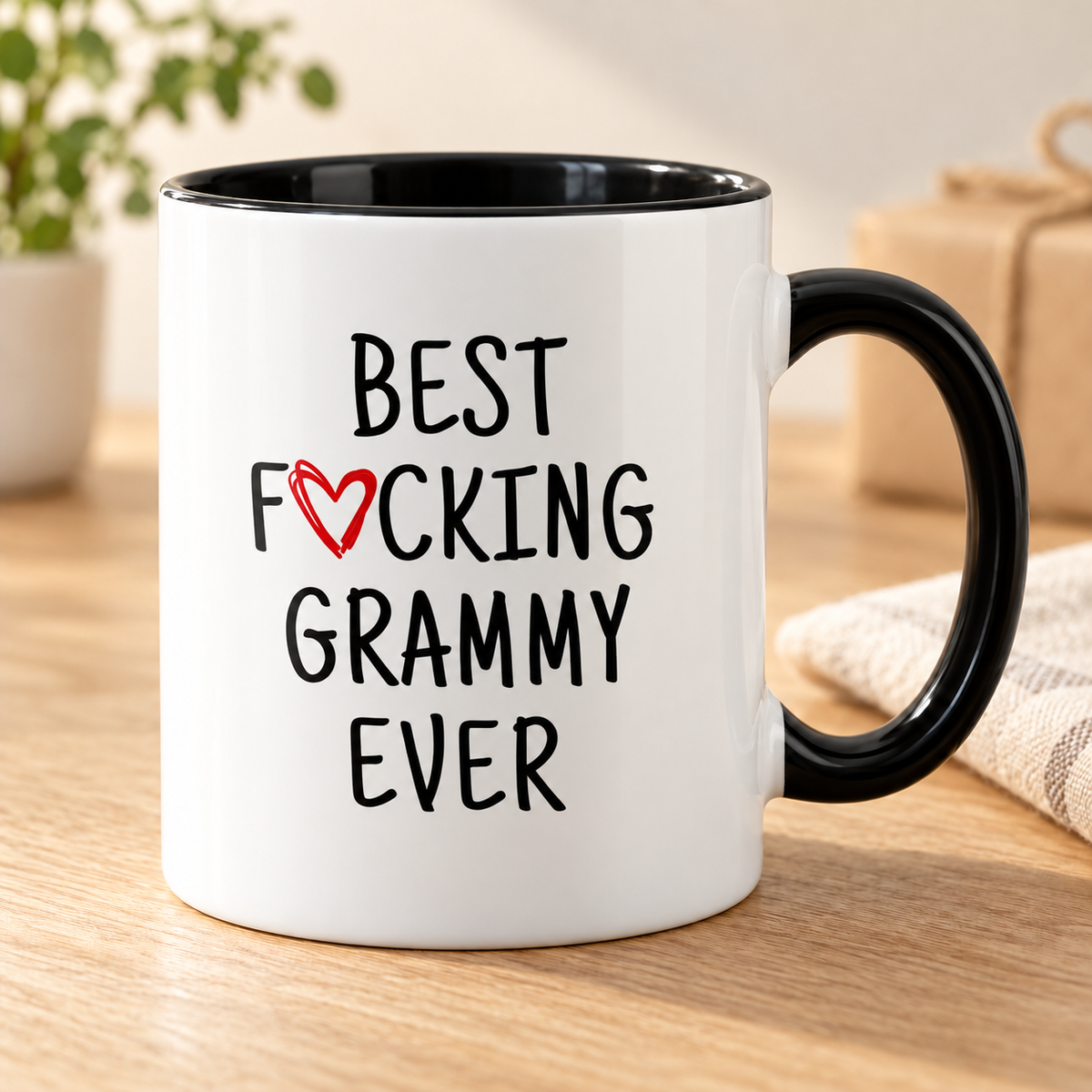 Best F cking Grammy Ever Heart Mug Grammy Gifts Mother's Day Baby Shower Coffee Mug Tea Cup 11 ounce — mug on a sunlit oak table