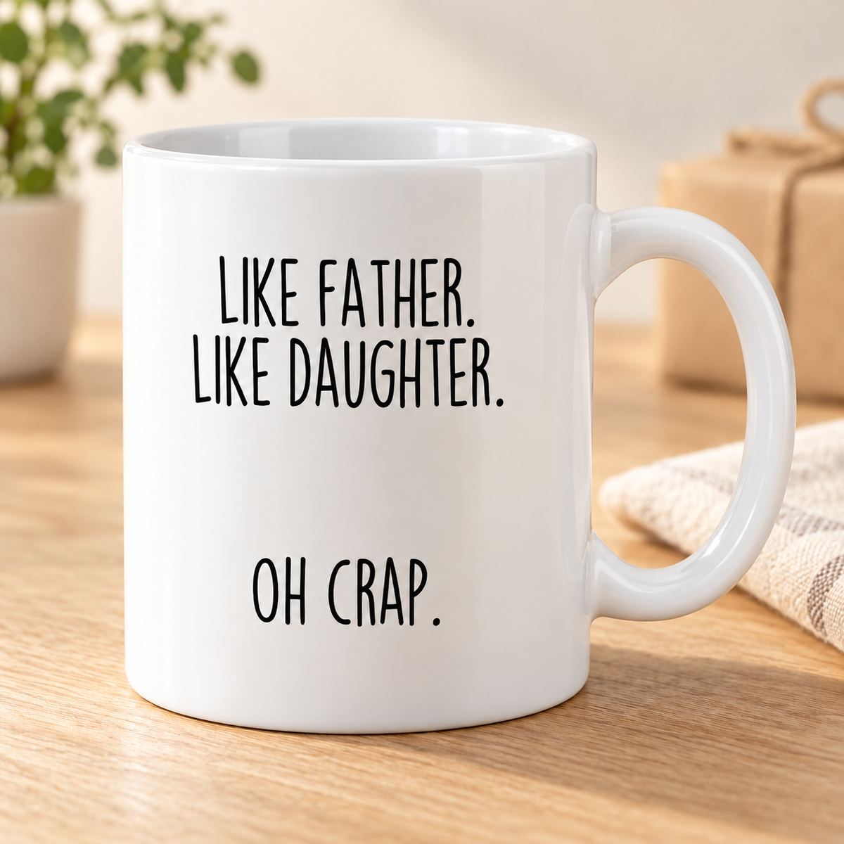 Like Father, Like Daughter, Oh Crap coffee mug — White variant, photographed on an oak table.