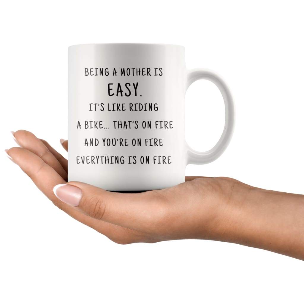 Being A Mother Is Easy. It's Like Riding A Bike... That's On Fire. And Your On Fire. Everything Is On Fire Coffee Mug - BackyardPeaks