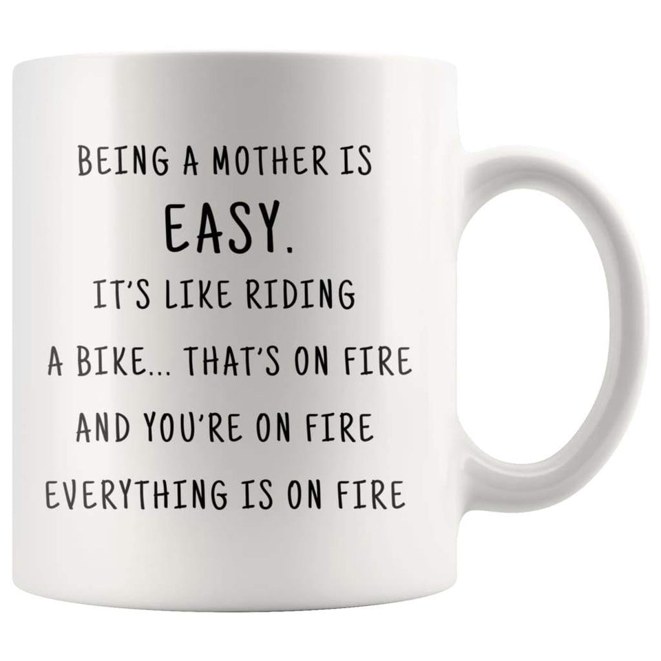 Being A Mother Is Easy. It's Like Riding A Bike... That's On Fire. And Your On Fire. Everything Is On Fire Coffee Mug