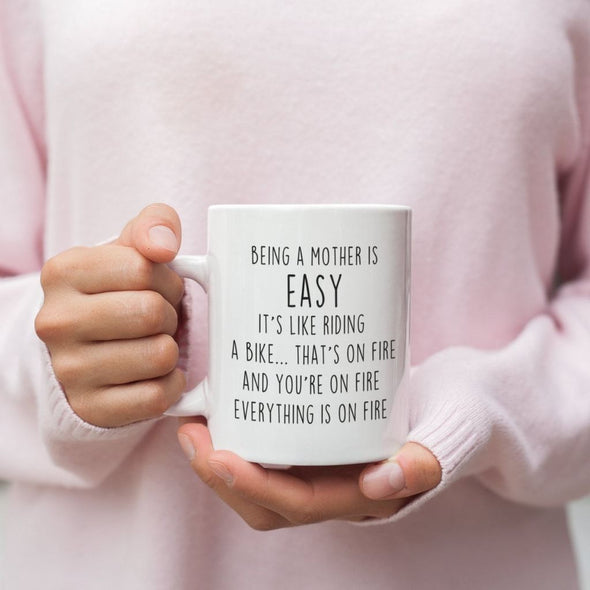 Being A Mother Is Easy. Its Like Riding A Bike... Thats On Fire. And Your On Fire. Everything Is On Fire Coffee Mug $14.99 | Drinkware