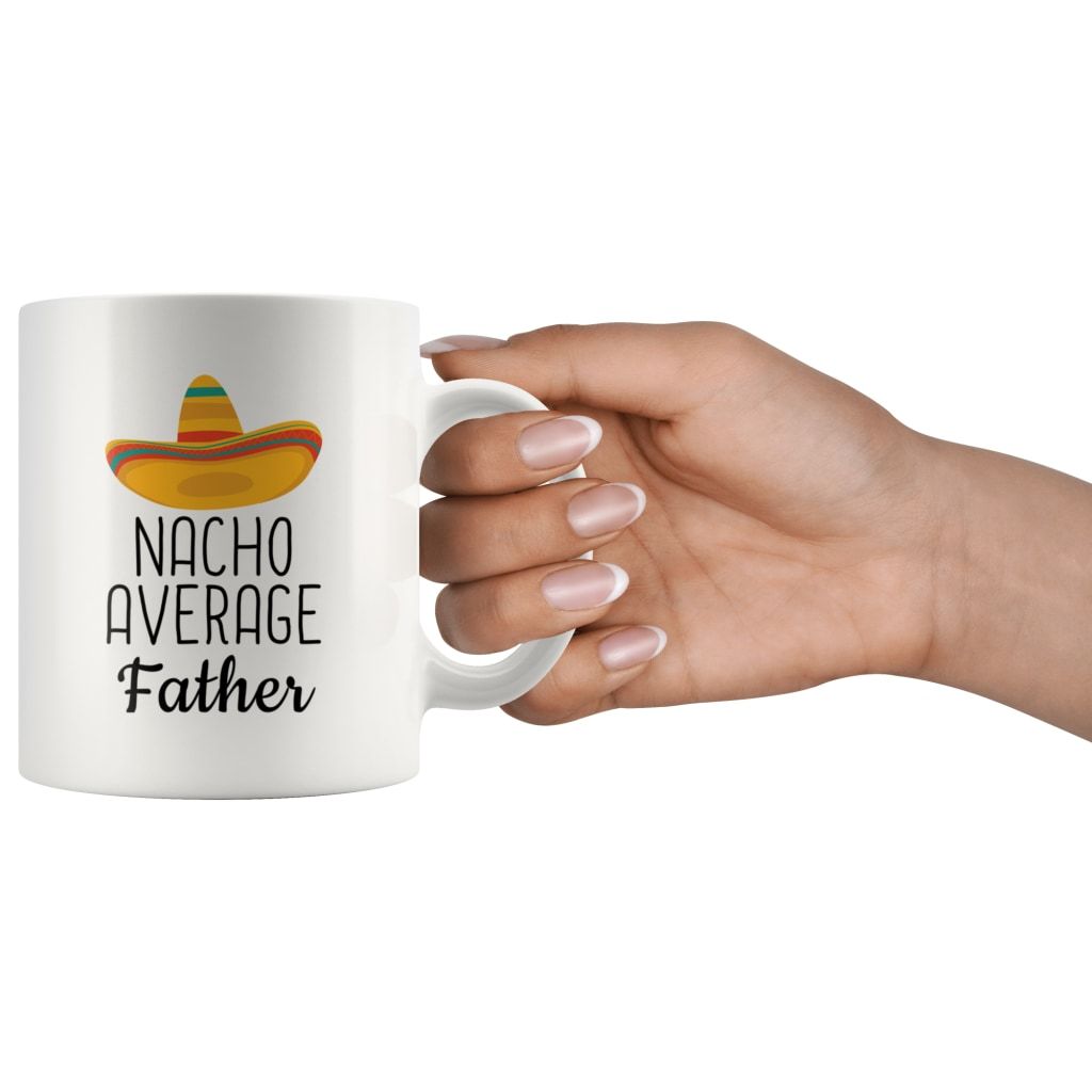 Hand holding a white Nacho Average Father mug by its handle